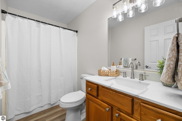 bathroom featuring vanity, toilet, and wood finished floors