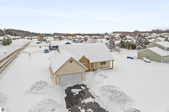 snowy aerial view featuring a residential view