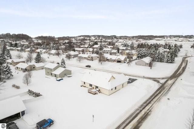 snowy aerial view featuring a residential view