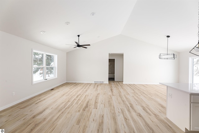 unfurnished living room with ceiling fan, lofted ceiling, and light hardwood / wood-style floors