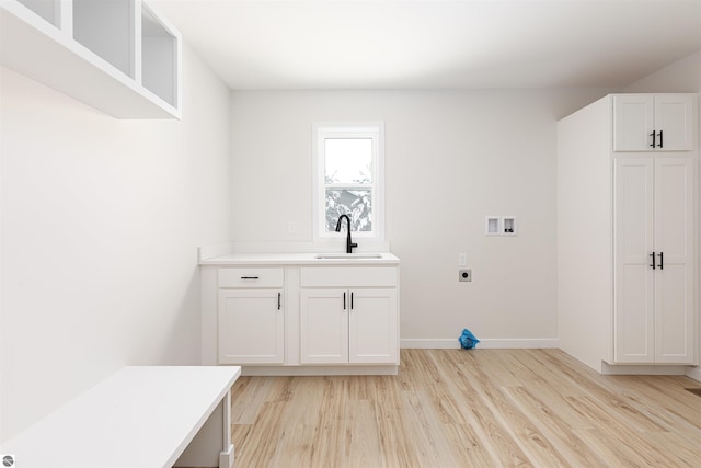 laundry room featuring electric dryer hookup, sink, hookup for a washing machine, and light wood-type flooring