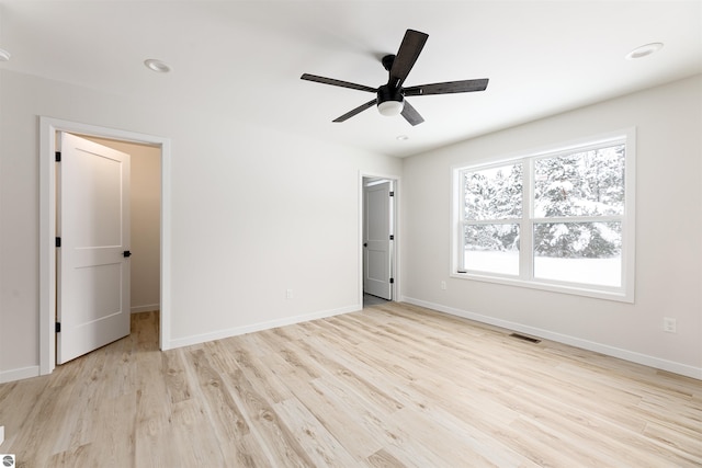 unfurnished room with ceiling fan and light wood-type flooring