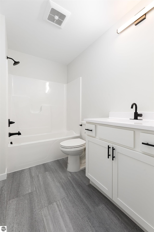 full bathroom with vanity, toilet, tub / shower combination, and wood-type flooring