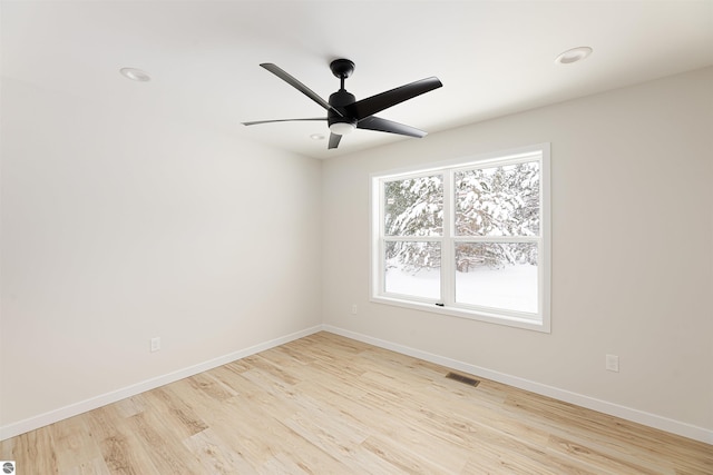 spare room with ceiling fan and light hardwood / wood-style flooring