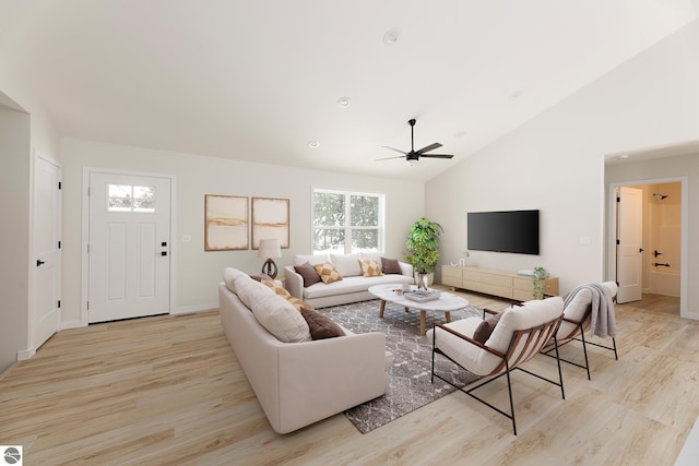 living room with ceiling fan, high vaulted ceiling, and light wood-type flooring