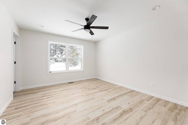 spare room featuring ceiling fan and light hardwood / wood-style flooring