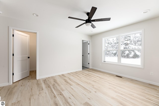 unfurnished bedroom with ceiling fan and light wood-type flooring