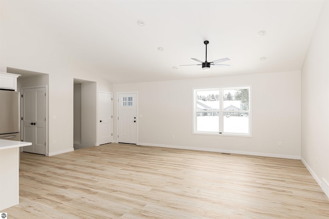 unfurnished living room featuring ceiling fan, lofted ceiling, and light hardwood / wood-style floors