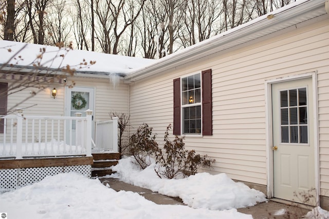 view of snow covered property entrance