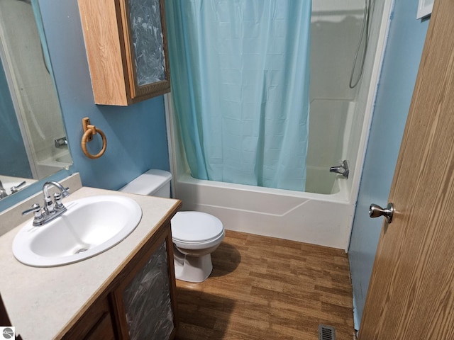 full bathroom featuring vanity, wood-type flooring, toilet, and shower / bath combo with shower curtain