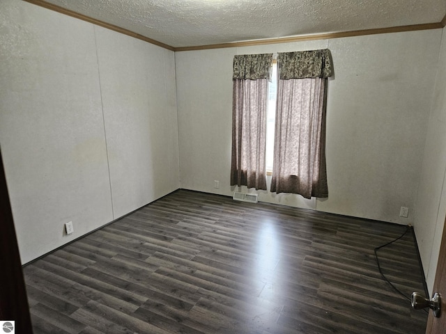 unfurnished room with crown molding, dark hardwood / wood-style floors, and a textured ceiling