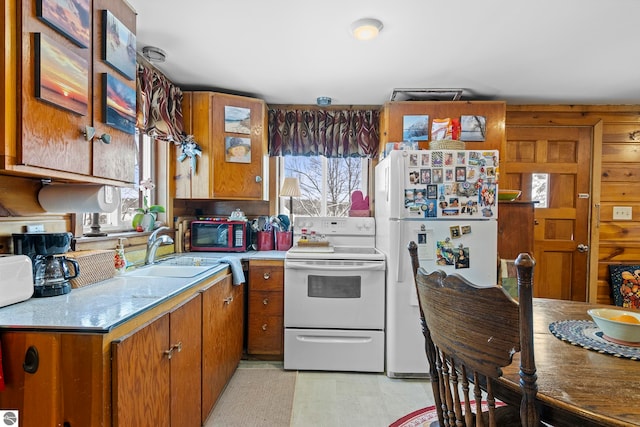 kitchen with white appliances, plenty of natural light, and sink