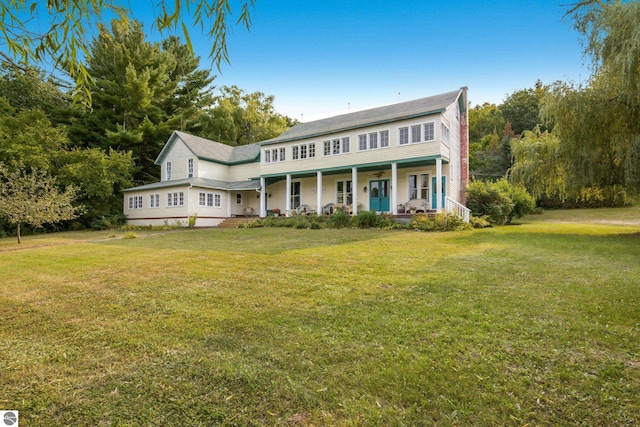 view of front of home with a porch and a front lawn