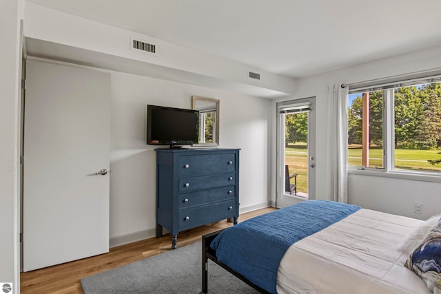 bedroom featuring access to outside and light wood-type flooring