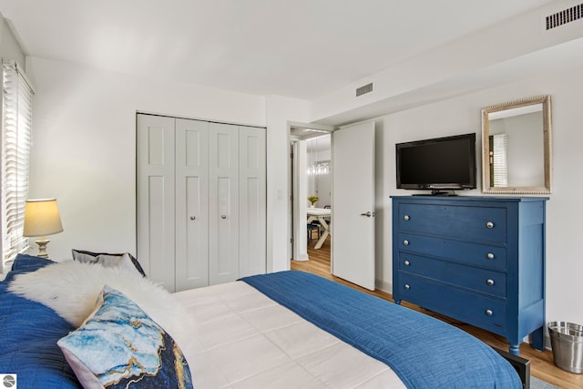 bedroom with a closet and light hardwood / wood-style flooring