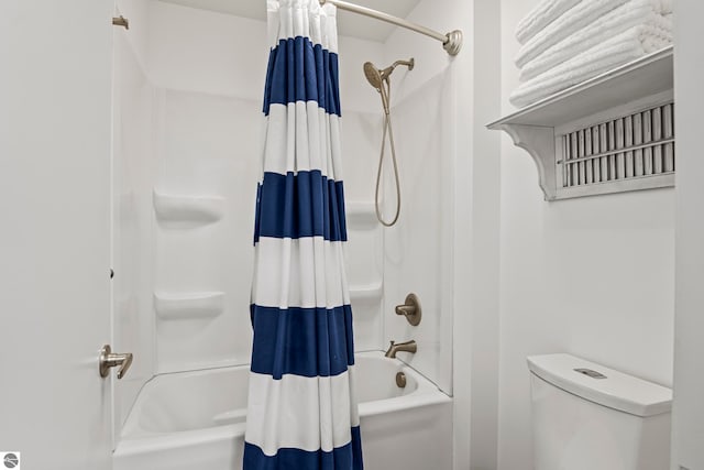 bathroom with shower / tub combo with curtain and toilet