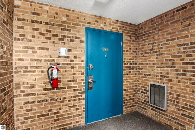 doorway to property featuring heating unit