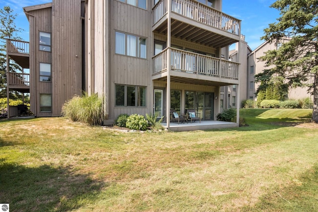 back of property featuring a patio and a yard