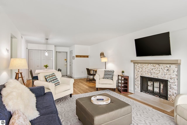 living room with hardwood / wood-style flooring and a tile fireplace