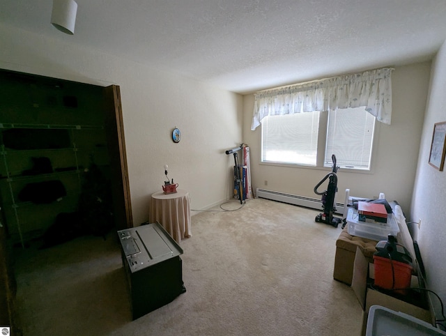 exercise room with carpet floors, a textured ceiling, and baseboard heating