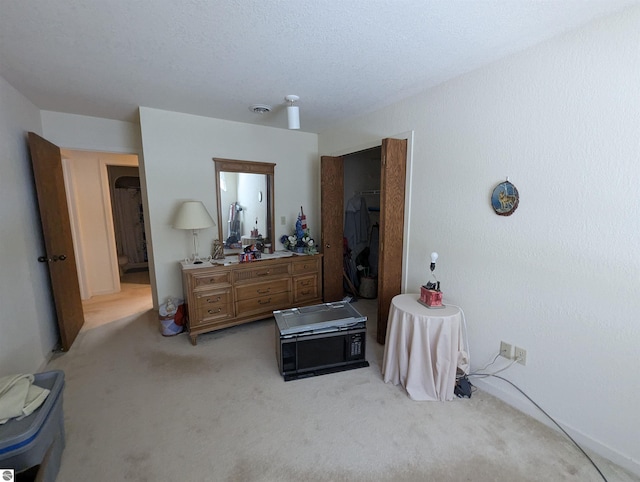 carpeted bedroom featuring a textured ceiling