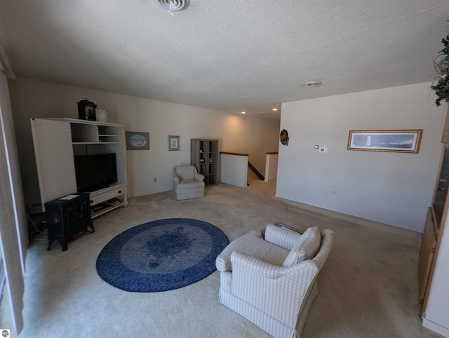 carpeted living room with a textured ceiling