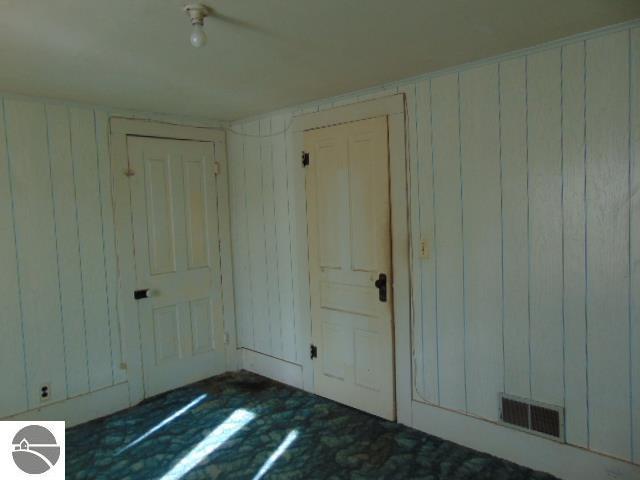 interior space with visible vents and wooden walls