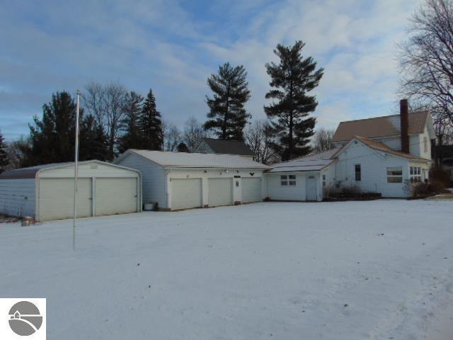 snowy yard featuring a garage