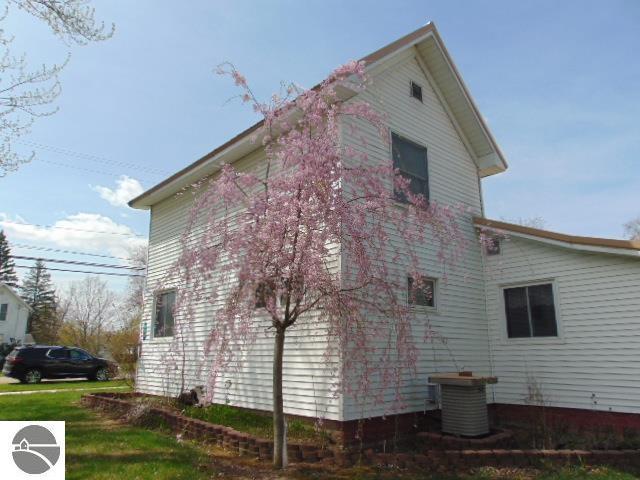 view of side of property featuring central air condition unit