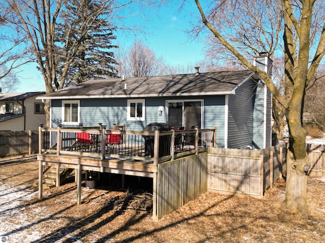 back of property with a wooden deck