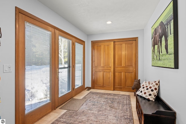 entryway featuring light tile patterned floors