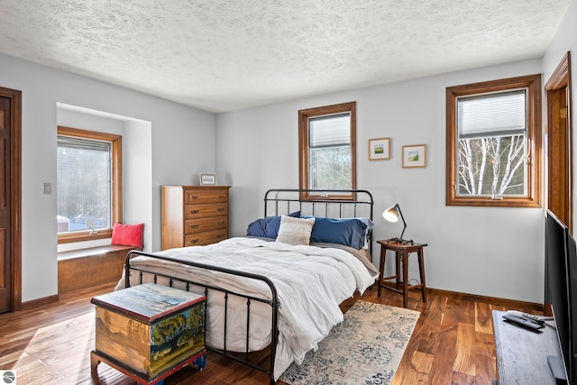 bedroom with wood-type flooring and a textured ceiling