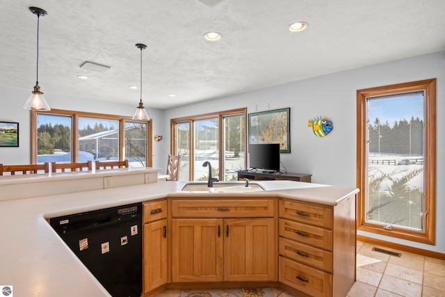 kitchen featuring sink, hanging light fixtures, black dishwasher, a textured ceiling, and kitchen peninsula