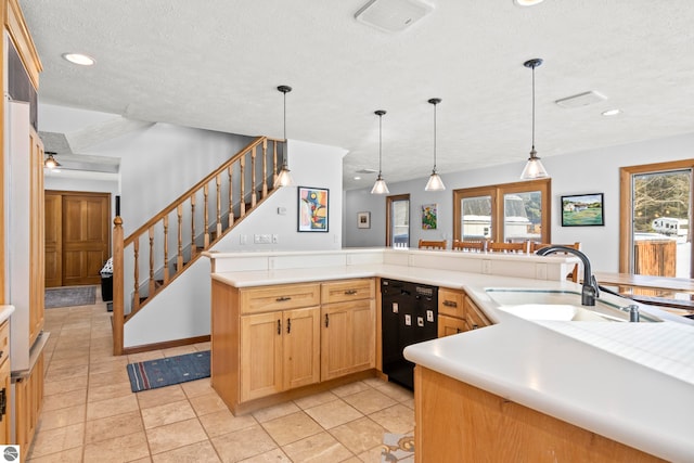 kitchen with dishwasher, sink, a healthy amount of sunlight, and decorative light fixtures