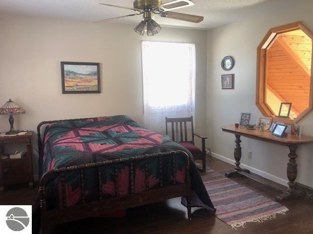 bedroom with dark wood-type flooring and ceiling fan