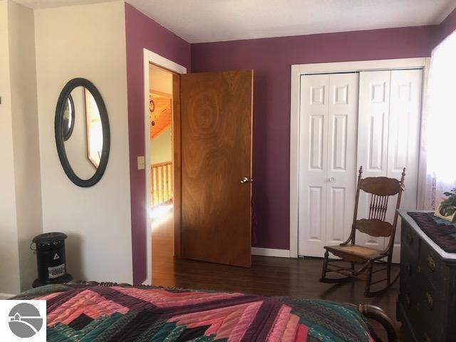 bedroom featuring dark wood-type flooring and a closet