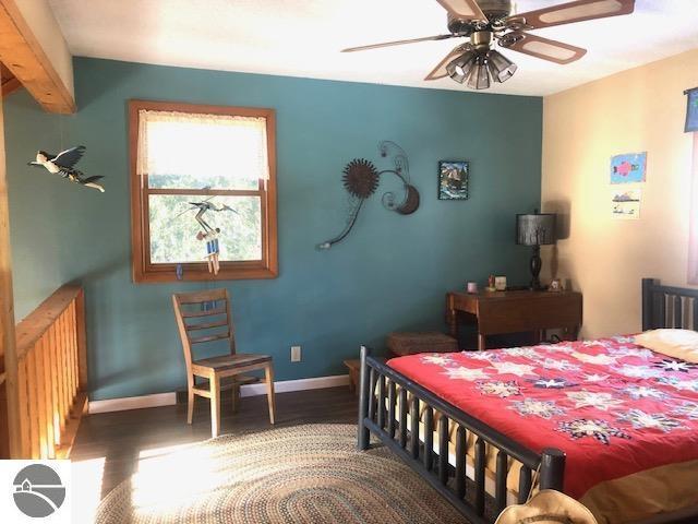 bedroom featuring hardwood / wood-style floors and radiator heating unit