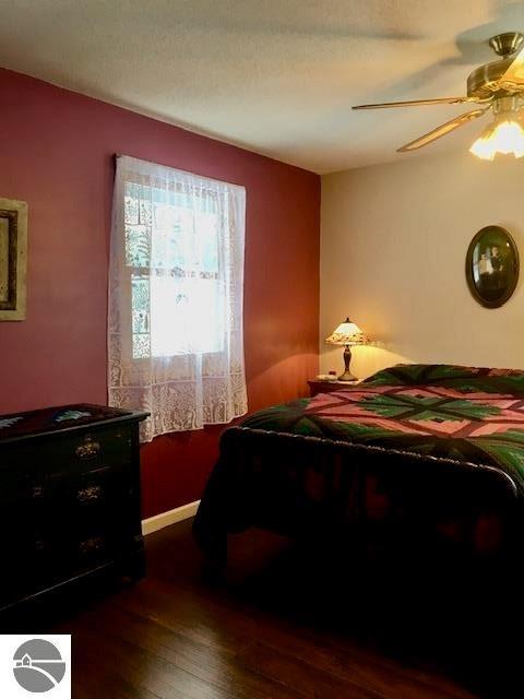 bedroom featuring dark wood-type flooring and ceiling fan