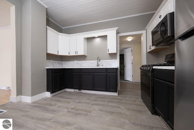 kitchen featuring crown molding, white cabinets, light wood-type flooring, and black appliances