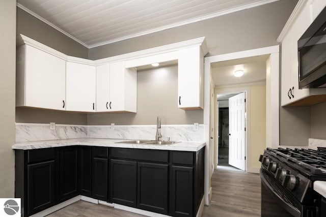 kitchen featuring sink, white cabinetry, crown molding, light wood-type flooring, and black appliances