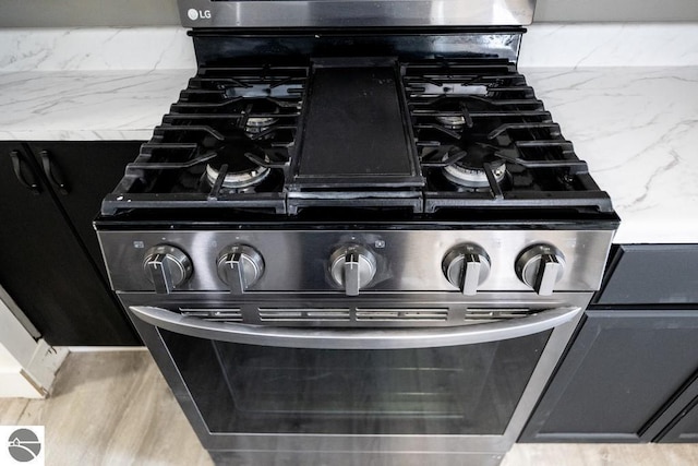 room details with stainless steel gas range oven and light stone counters