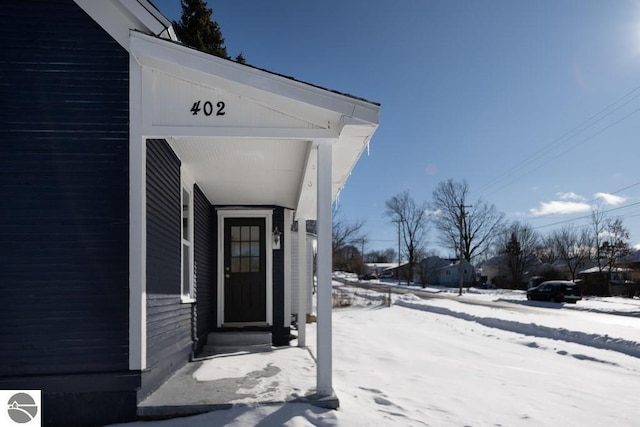 view of snow covered property entrance