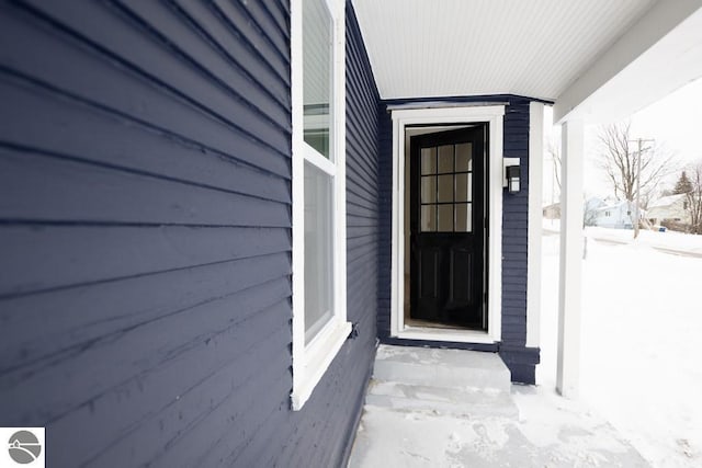 view of snow covered property entrance