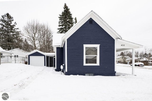 view of snow covered exterior featuring a garage