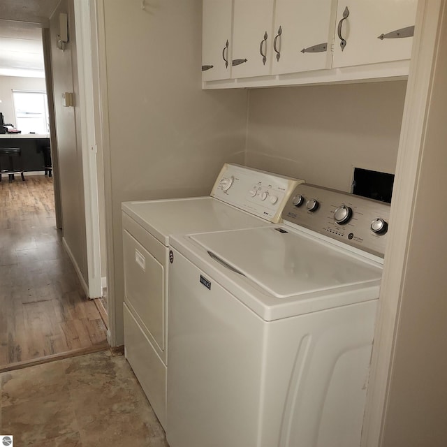 laundry room with cabinets and washing machine and clothes dryer