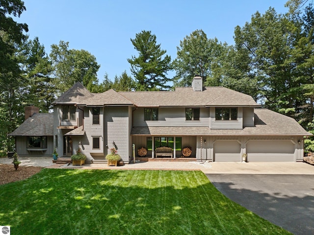 view of front of house featuring a garage and a front lawn