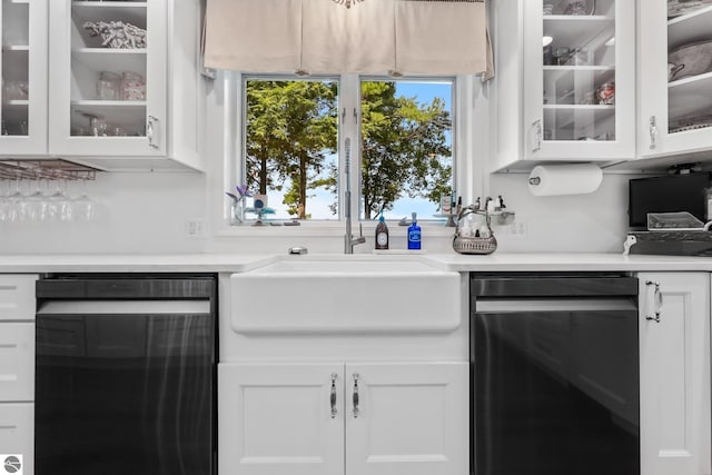 kitchen with black dishwasher, sink, and white cabinets