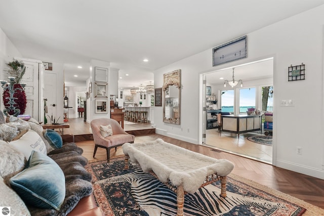 living room with parquet floors and a notable chandelier