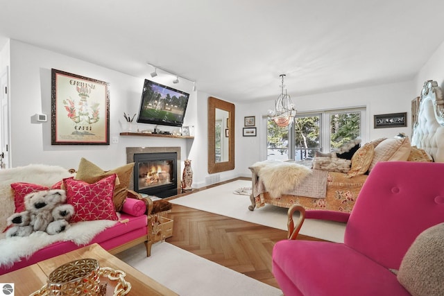 bedroom with parquet floors, rail lighting, and a notable chandelier