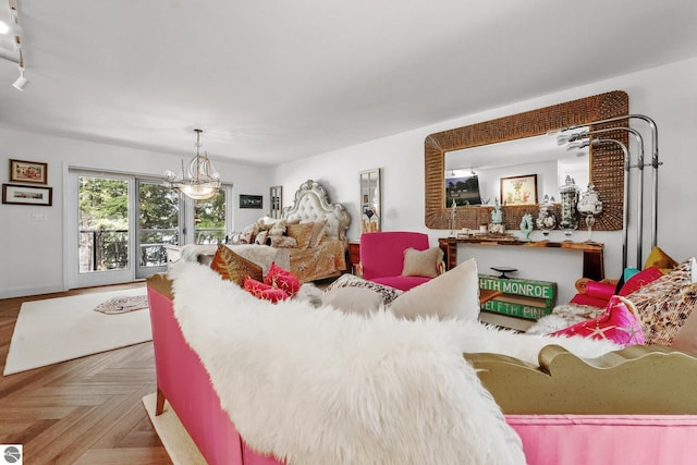 bedroom with parquet floors, access to outside, and a chandelier